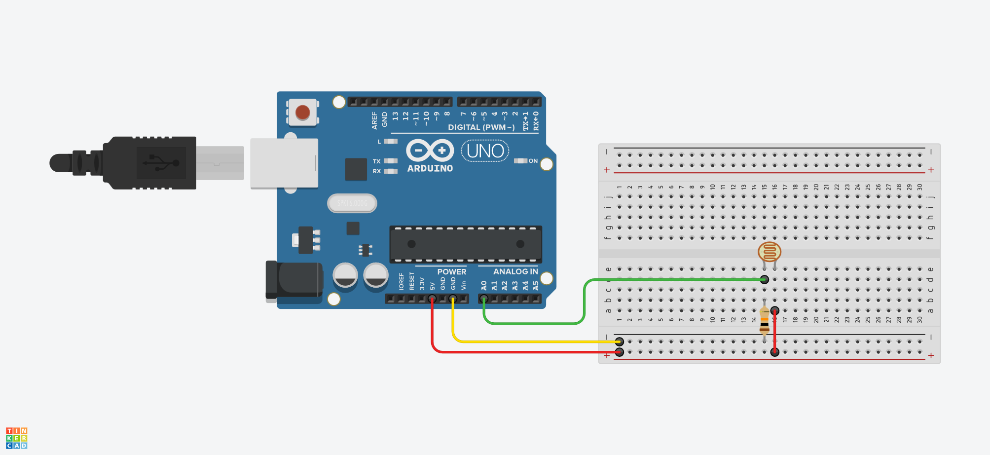 دائرة Voltage Divider بمقاومة ضوئية ومقاومة 10kΩ، مع توصيل نقطة الالتقاء إلى A0